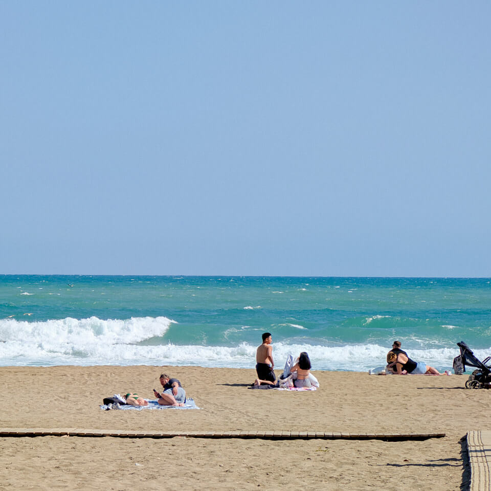 People sitting on a beach during a sunny day