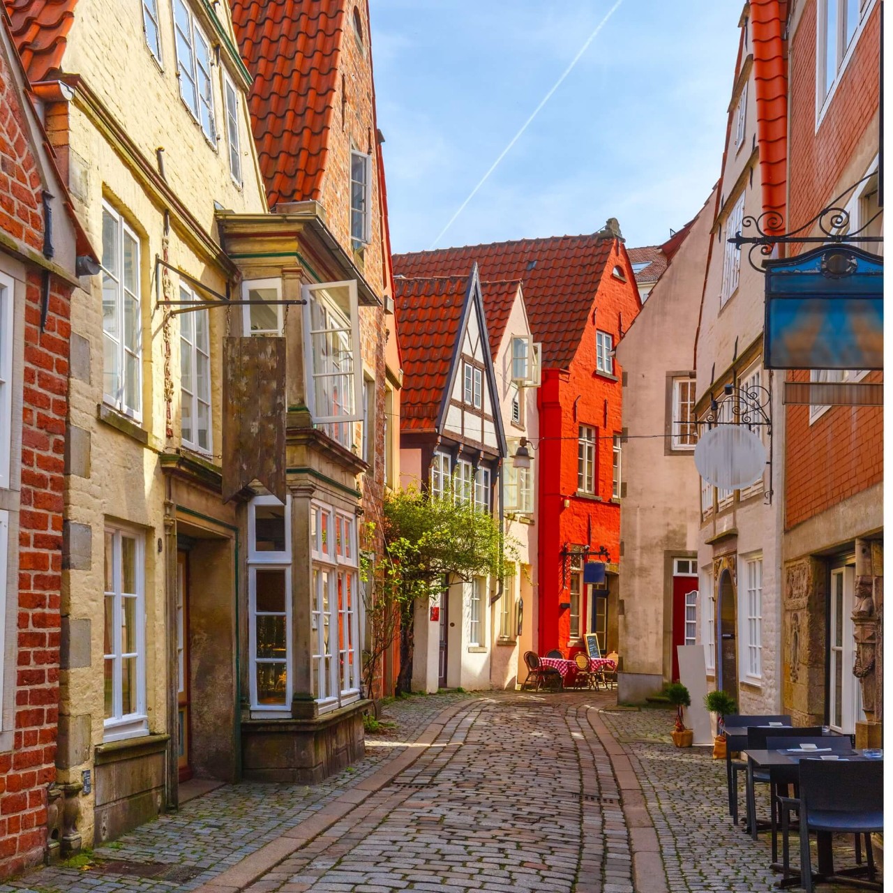 A quiet, cobble-stoned street in Bremen, with colourful half-timbered houses